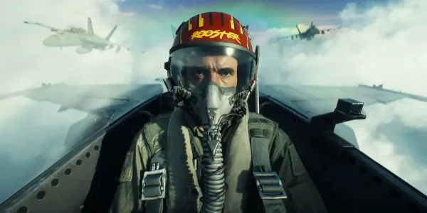 A fighter pilot wearing a helmet labeled Rooster inside a jet cockpit high above the clouds, illustrating our Battlefield 6 Top Gun jet controls guide.
