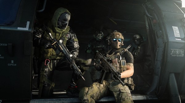 Squad of Operators holding weapons inside a helicopter bay, illustrating a MW4 prestige system explained guide.