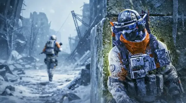 A close-up of a Raider soldier in full tactical winter gear and a blue helmet visor, taking cover behind a snowy stone wall in a destroyed, snowy urban combat zone, referencing gameplay from the Arc Raiders Frozen Trail update. In the distance, another Raider moves through the snow toward dilapidated buildings.